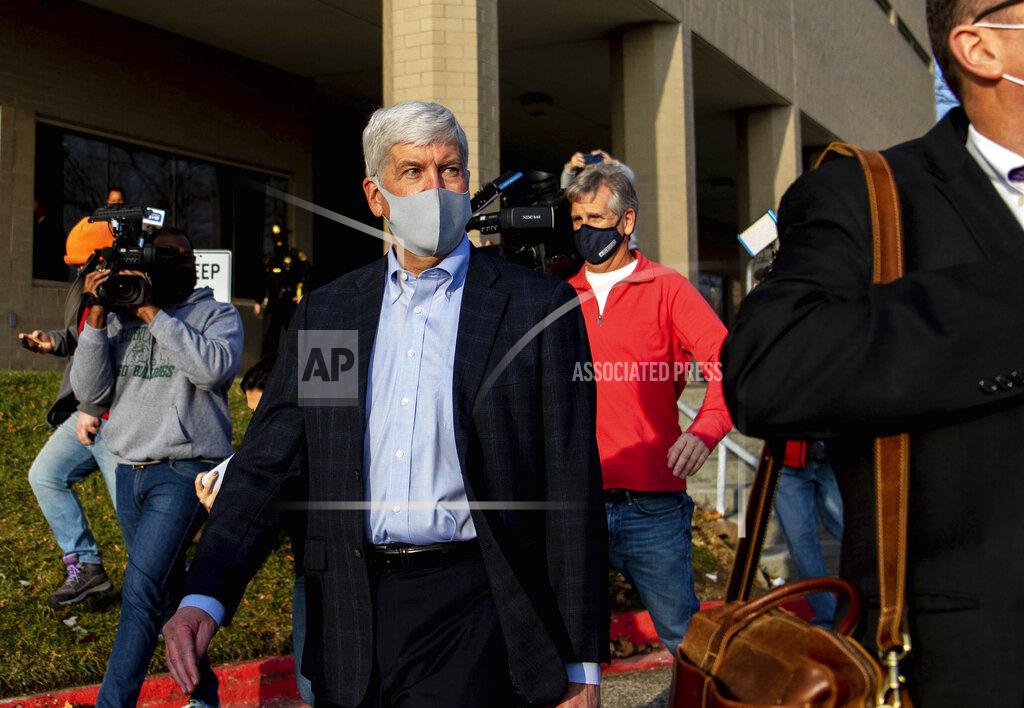 Cody Scanlan Former Gov. Rick Snyder walks past the media after his video arraignment on charges related to the Flint water crisis on Thursday, Jan. 14, 2021 outside the Genesee County Jail in downtown Flint. Snyder pleaded not guilty to misdemeanor charges of willful neglect of duty in Flint. (Cody Scanlan/The Flint Journal via AP)
