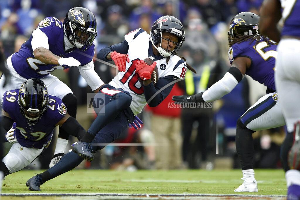 Gail Burton Houston Texans wide receiver DeAndre Hopkins (10) pushes forward after a catch as Baltimore Ravens free safety Earl Thomas (29), cornerback Jimmy Smith (22) and middle linebacker Josh Bynes (57) try to stop him during the first half of an NFL football game, Sunday, Nov. 17, 2019, in Baltimore. (AP Photo/Gail Burton)