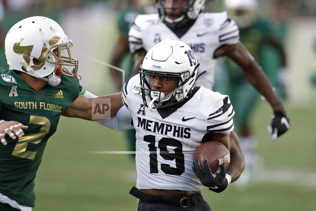Chris O'meara Memphis running back Kenneth Gainwell (19) pushes off South Florida defensive back Nick Roberts (2) during the first half of an NCAA college football game Saturday, Nov. 23, 2019, in Tampa, Fla. (AP Photo/Chris O'Meara)