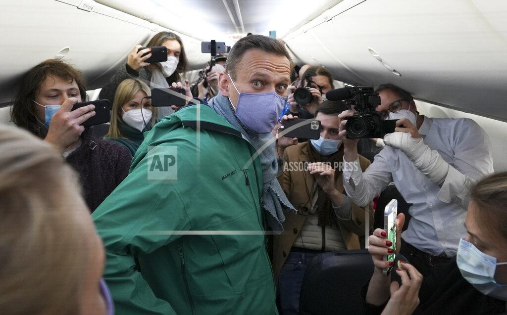Mstyslav Chernov FILE - In this Jan. 17, 2021, file photo, Alexei Navalny is surrounded by journalists inside the plane prior to his flight to Moscow in the Airport Berlin Brandenburg (BER) in Schoenefeld, near Berlin, Germany. The return of Navalny from Germany after he spent five months in Berlin recovering from a nerve agent poisoning was marked by chaos and popular outrage, and it ended, almost predictably with his arrest. The Jan. 17 flight carried him and his wife, along with a group of journalists documenting the journey. (AP Photo/Mstyslav Chernov, File)