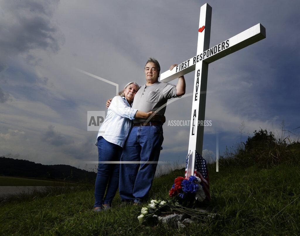 Mark Humphrey FILE - In this Aug. 6, 2019, photo, Ansol and Janie Clark pose at a memorial Ansol Clark constructed near the Kingston Fossil Plant in Kingston, Tenn. The Tennessee Valley Authority was responsible for a massive coal ash spill at the plant in 2008 that covered a community and fouled rivers. The couple says the memorial is for the workers who have come down with illnesses, some fatal, including cancers of the lung, brain, blood and skin and chronic obstructive pulmonary disease. Ansol Clark who drove a fuel truck for four years at the cleanup site, and suffered from a rare blood cancer, has also died now. (AP Photo/Mark Humphrey, File)