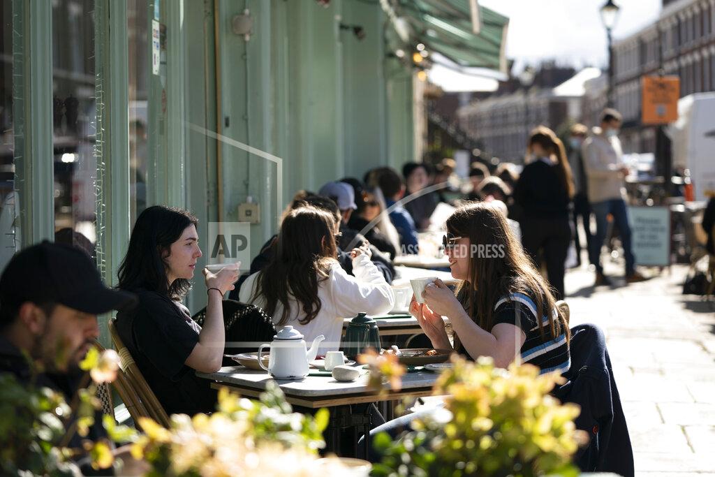 Jon Super Customers sit outside a restaurant in Liverpool, Monday, April 12, 2021, as restaurants, bars and pubs can open and serve people who can be seated outside. Millions of people in England will get their first chance in months for haircuts, casual shopping and restaurant meals on Monday, as the government takes the next step on its coronavirus lockdown-lifting road map. (AP Photo Jon Super)