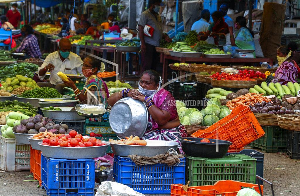 Mahesh Kumar A Indian vendors wearing face masks as a precaution against coronavirus wait for customers at a vegetable market in Hyderabad, India, Thursday, June 24, 2021. (AP Photo/Mahesh Kumar A.)