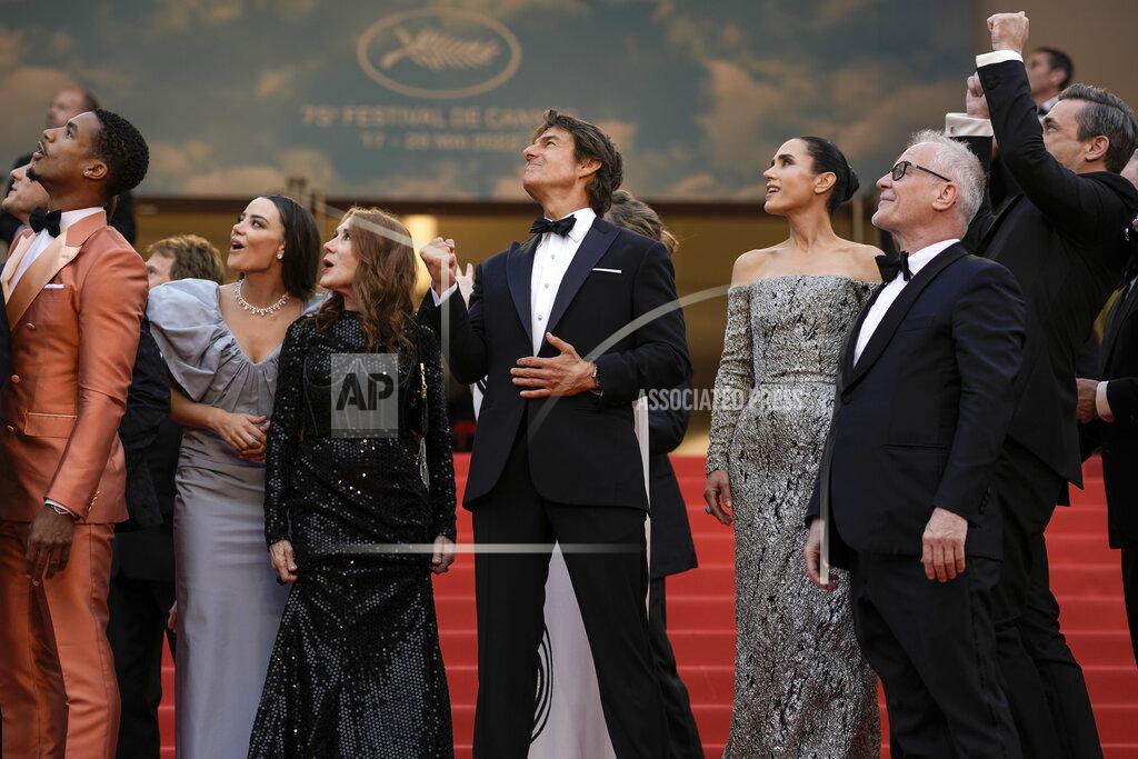 Petros Giannakouris Tom Cruise, center, poses with the Greg Tarzan Davis, from left, Keleigh Sperry, Linda Bruckheimer, Jennifer Connelly, festival director Thierry Fremaux, and Jon Hamm after French Alpha Jets Patrouille de France fly over the red carpet at the premiere of the film 'Top Gun: Maverick' at the 75th international film festival, Cannes, southern France, Wednesday, May 18, 2022. (AP Photo/Petros Giannakouris)