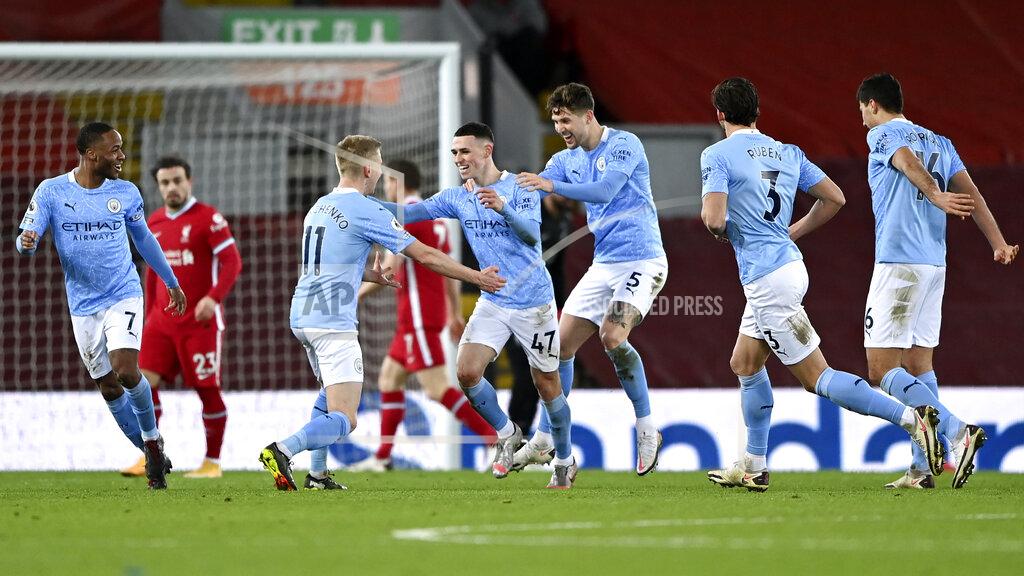 Laurence Griffiths Manchester City's Phil Foden, center, celebrates after scoring his side's fourth goal during the English Premier League soccer match between Liverpool and Manchester City at Anfield Stadium, Liverpool, England, Sunday, Feb. 7, 2021. (Laurence Griffiths/Pool via AP)
