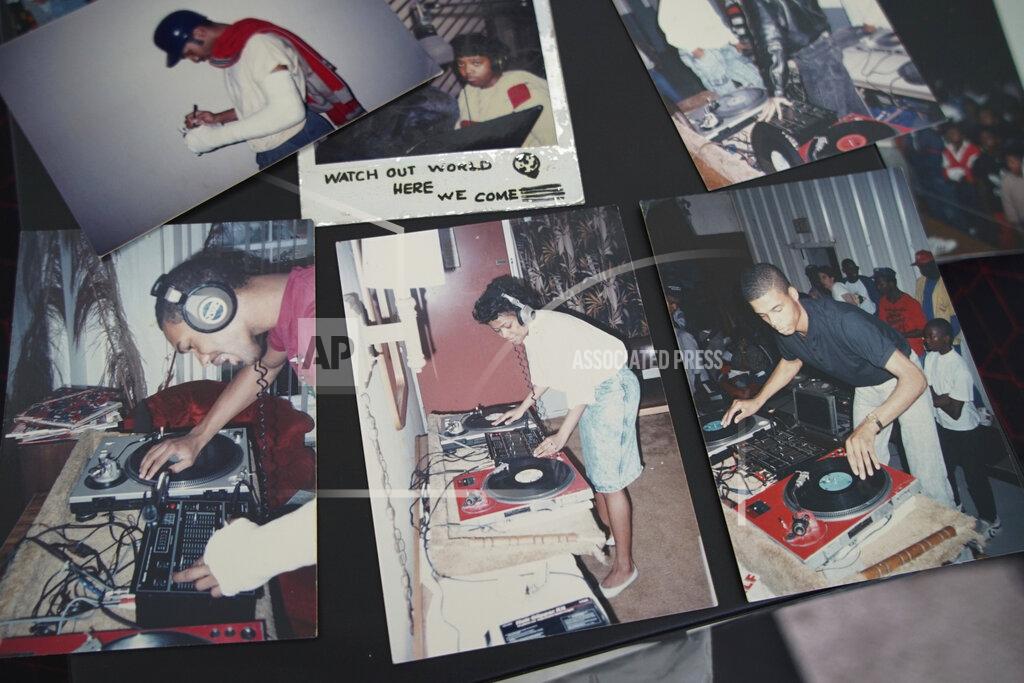 Allen G. Breed Old photos of Alton Lucas, top and bottom on left, and musician DJ Nabs, lower right, are assembled in a scrapbook in Nabs' home studio outside of Raleigh, N.C., on Saturday, June 26, 2021. As a teenager, Lucas believed basketball or music would pluck him out of North Carolina and take him around the world. In the late 1980s, he was already the right-hand man to his musically inclined best friend, Youtha Anthony Fowler, who many hip-hop and R&B heads know today as DJ Nabs. (AP Photo/Allen G. Breed)