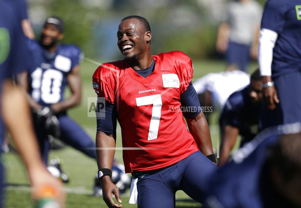 Elaine Thompson FILE - In this July 27, 2014, file photo, Seattle Seahawks quarterback Tarvaris Jackson smiles while stretching at an NFL football camp practice in Renton, Wash. Former NFL quarterback Tarvaris Jackson has died in a one-car crash outside Montgomery, Ala., authorities said Monday, April 13, 2020. He was 36. The 2012 Chevrolet Camaro that Jackson was driving went off the road, struck a tree and overturned at 8:50 p.m. Sunday, Trooper Benjamin “Michael” Carswell, an Alabama Law Enforcement Agency spokesman, said in a news release. Jackson was pronounced dead at a hospital. (AP Photo/Elaine Thompson, File)