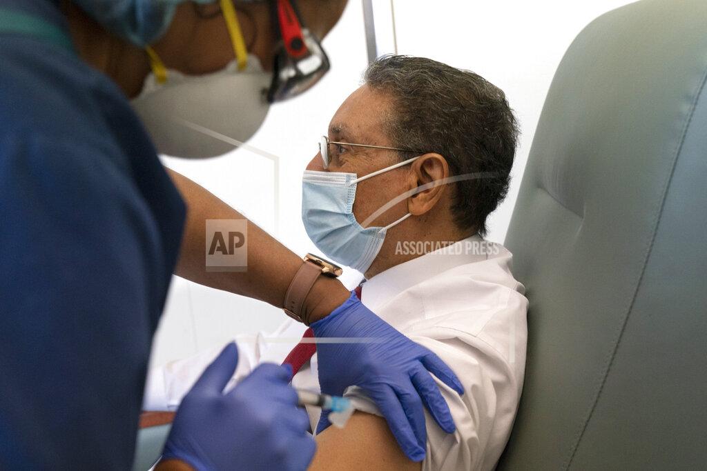 Jacquelyn Martin In this Wednesday, Feb. 10, 2021, photo Wallace Charles Smith, 72, who is a pastor at Shiloh Baptist Church, receives his first COVID-19 vaccination by nurse Michelle Martin, at United Medical Center in southeast Washington. (AP Photo/Jacquelyn Martin)
