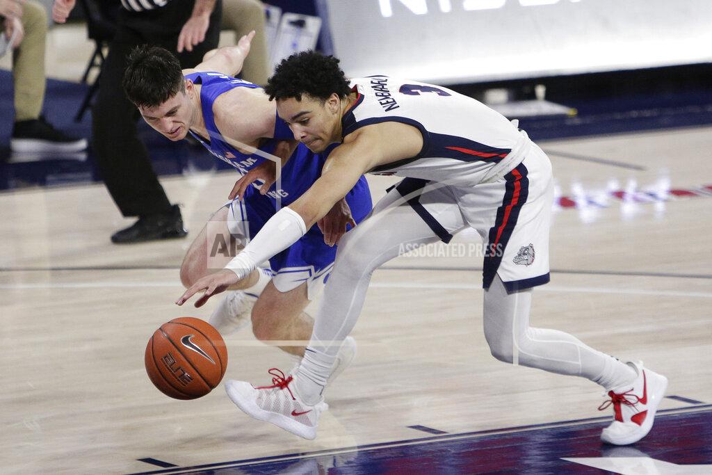 Young Kwak BYU guard Alex Barcello,left, and Gonzaga guard Andrew Nembhard go after the ball during the first half of an NCAA college basketball game in Spokane, Wash., Thursday, Jan. 7, 2021. (AP Photo/Young Kwak)