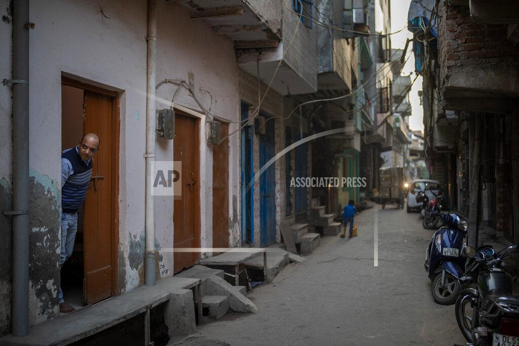 Altaf Qadri Muhammad Nasir Khan, who was shot by a Hindu mob during the February 2020 communal riots, looks out from his home in North Ghonda, one of the worst riot affected neighborhood, in New Delhi, India, Friday, Feb. 19, 2021. As the first anniversary of bloody communal riots that convulsed the Indian capital approaches, Muslim victims are still shaken and struggling to make sense of their struggle to seek justice. (AP Photo/Altaf Qadri)
