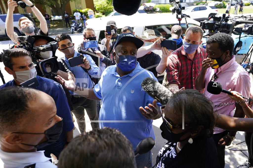 Steve Helber Elijah Dillard, center, is surrounded by media as he makes comments after a judges decision on the release body cam video of the shooting of Andrew Brown Jr. in Elizabeth City, N.C., Wednesday, April 28, 2021. A judge denied the request to immediately release body cam video of the incident. (AP Photo/Steve Helber)