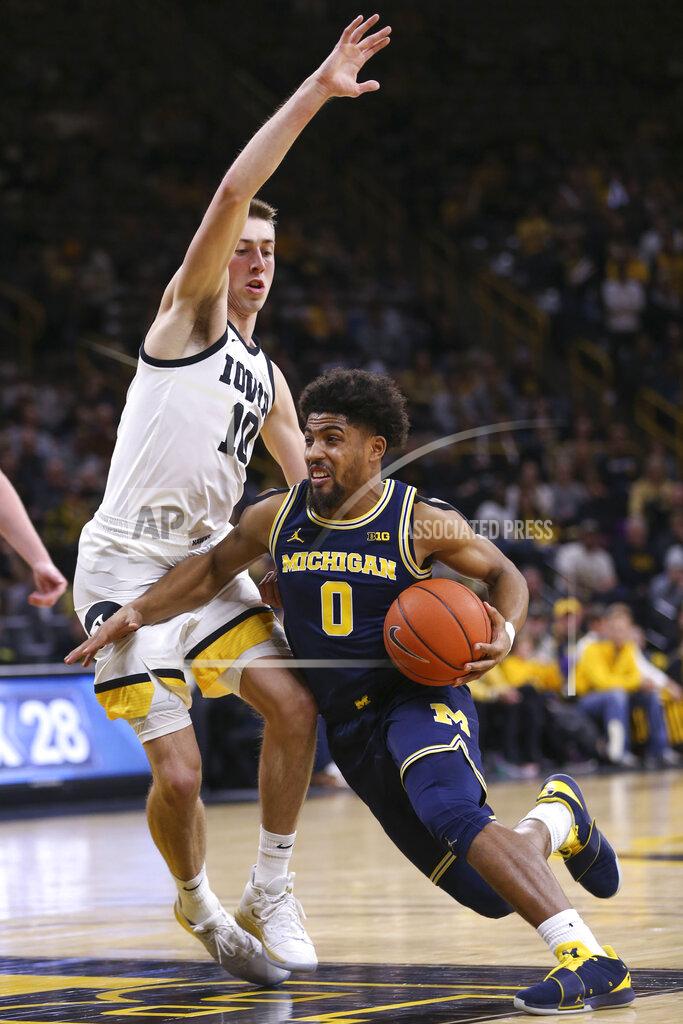 Rebecca F. Miller Michigan guard David DeJulius (0) drives the ball around Iowa guard Joe Wieskamp (10) during the first half of an NCAA college basketball game Friday, Jan. 17, 2020, in Iowa City, Iowa. (Rebecca F. Miller/The Gazette via AP)