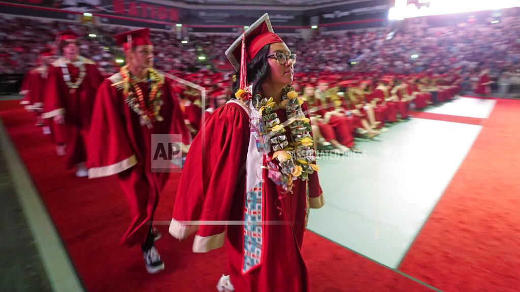 Rick Bowmer Amryn Tom graduates from Cedar City High School on Wednesday, May 25, 2022, in Cedar City, Utah. Tom is wearing an eagle feather given to her by her mother and a cap that a family friend beaded. (AP Photo/Rick Bowmer)