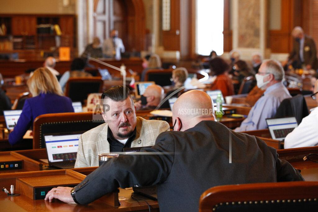 John Hanna Kansas state Rep. Bill Sutton, left, R-Gardner, confers with Rep. Adam Thomas, right, R-Olathe, as the House debates a proposed anti-abortion amendment to the Kansas Constitution, Friday, Jan. 22, 2021, at the Statehouse in Topeka, Kan. The debate came on the 48th anniversary of the U.S. Supreme Court's historic 1973 Roe v. Wade decision legalizing abortion nationwide. (AP Photo/John Hanna, Pool)