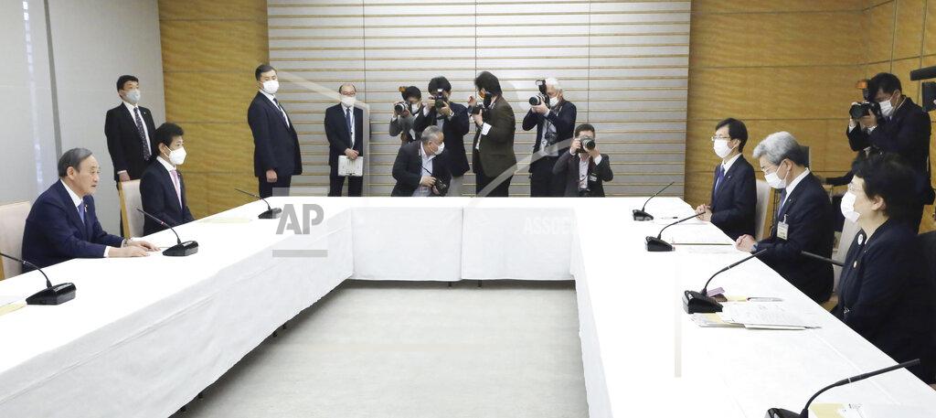 Toshiyuki Matsumoto Japanese Prime Minister Yoshihide Suga, left, holds a meeting with Toshiko Fukui, right, president of the Japanese Nursing Association, and Toshio Nakagawa, second from right, president of the Japan Medical Association, at his office in Tokyo on April 30, 2021. Some nurses in Japan are incensed at a request from Tokyo Olympic organizers to have 500 of them dispatched to help out with the games. They say they’re already near the breaking point dealing with the coronavirus pandemic. (Toshiyuki Matsumoto/Kyodo News via AP)
