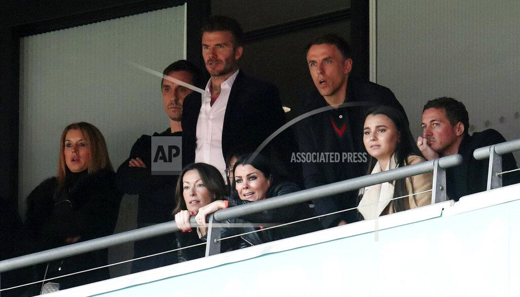 Bradley Collyer Salford City co-owners Gary Neville, second left, David Beckham, center, and Phil Neville watch the National League Play-off Soccer Final at Wembley Stadium, London, Saturday, May 11, 2019. David Beckham watched on at Wembley as Salford secured their Football League place with a 3-0 win over AFC Fylde in the Vanarama National League play-off final. The former England captain joined some of his fellow co-owners from Manchester United's 'Class of 92' to cheer on Graham Alexander's side as the club secured promotion to the Football League for the first time. (Bradley Collyer/PA via AP)