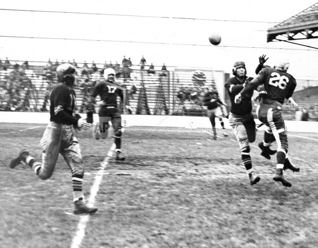 Murray Becker FILE - In this Nov. 10, 1935, file photo, Brooklyn Dodgers' Ralph Kerchavel (26) bats away a pass for an unidentified Pittsburgh Pirates player, second from right, that was caught by Pirates' Jim Levey, left, who carried the ball in for a touchdown at Ebbetts Field in Brooklyn, N.Y. The Pirates defeated the Dodgers 16-7. The NFL saw its biggest influx of teams for the decade in 1933, with the additions of the Philadelphia Eagles, Pittsburgh Pirates (later the Steelers) and Cincinnati Reds. (AP Photo/Murray Becker, File)