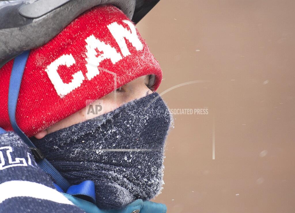 A man wears a face covering on a cold winter day in Montreal, Saturday, January 30, 2021, as the COVID-19 pandemic continues in Canada and around the world. (Graham Hughes/The Canadian Press via AP)