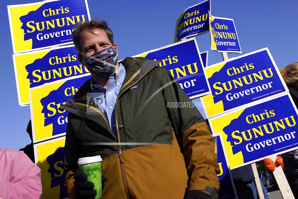 Charles Krupa N.H. Gov. Chris Sununu stands with supporters at a polling station at Windham, N.H. High School, Tuesday, Nov. 3, 2020, in Windham. Sununu, a Republican, faces Democrat Dan Feltes in the gubernatorial election. (AP Photo/Charles Krupa)