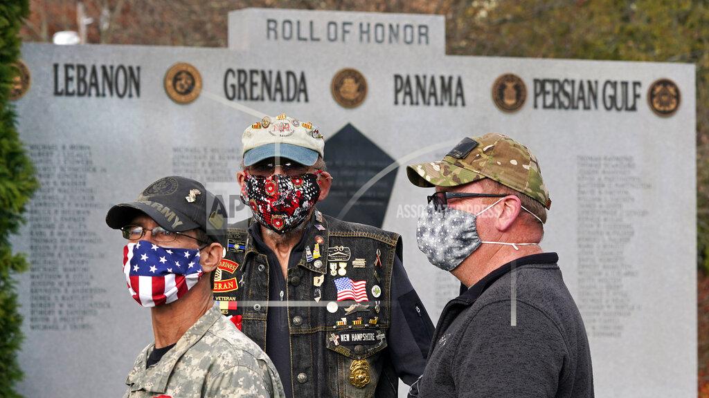 Charles Krupa FILE - In this Nov. 11, 2020, file photo, veterans, wear protective masks due to the COVID-19 virus outbreak during a Veterans Day ceremony in Derry, N.H. The coronavirus pandemic was New Hampshire's top story of 2020. (AP Photo/Charles Krupa)