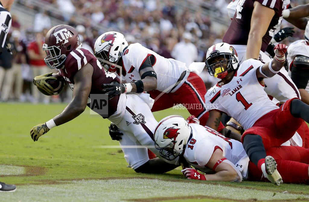 Sam Craft Texas A&M running back Isaiah Spiller (28) crosses the goal line for a touchdown as Lamar linebacker Dallas Martin (10) and defensive back Kyron Norwood (9) defend during the first half of an NCAA college football game, Saturday, Sept. 14, 2019, in College Station, Texas. (AP Photo/Sam Craft)