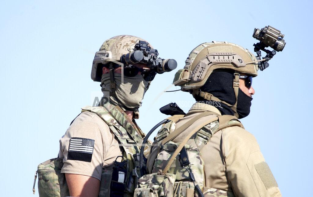 Philippos Christou A U.S. Navy SEAL special forces operator, left, stands with a colleague during a joint U.S.-Cyprus military drill at Limassol port on Friday, Sept. 10, 2021. Cyprus' Defense Minister Charalambos Petrides said the U.S. and Cyprus are on the same strategic path to ensure security and stability in a turbulent region and that continued close cooperation between the special forces of both countries aim to counter threats from potential terrorist acts. (AP Photo/Philippos Christou)