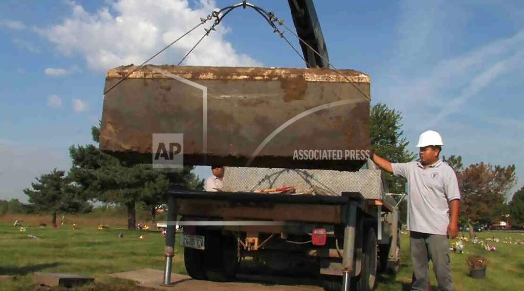 Uncredited FILE - In this undated file photo provided by the Cook County Sheriff's Office, authorities exhume a box with the remains of unidentified victims of serial killer John Wayne Gacy, who was convicted of killing 33 young men and boys in the Chicago area in the 1970s. Authorities announced Monday, Oct. 25, 2021, that they have identified the remains of one more of Gacy's victims. (AP Photo/Cook County Sheriff's Office, File)