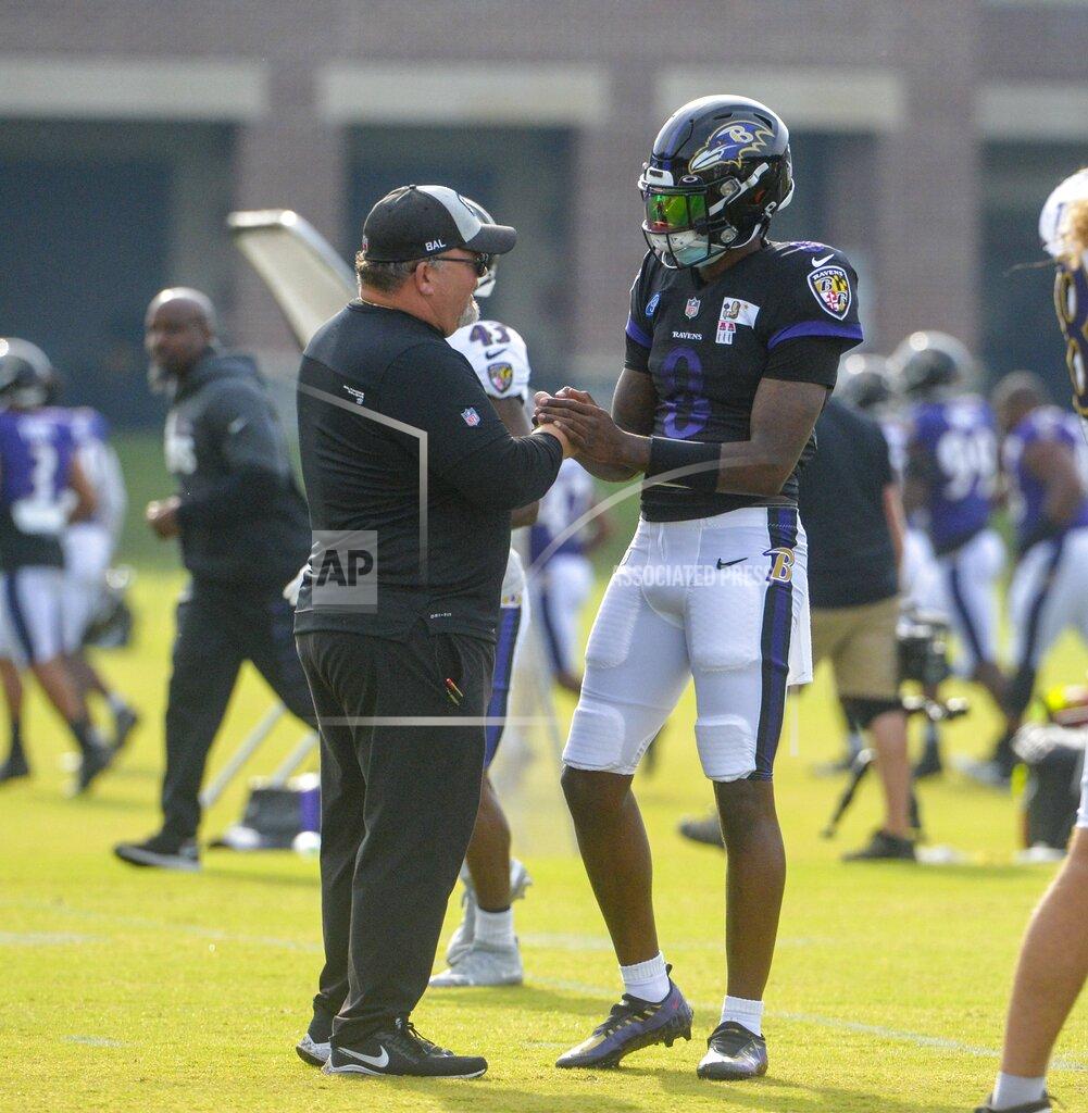 Kevin Richardson Baltimore Ravens quarterback Lamar Jackson, right, is greeted by offensive coordinator Greg Roman at the start of football practice during training camp at Under Armour Performance Center on Sunday, Aug. 7, 2021 in Owings Mills, Md. (Kevin Richardson/The Baltimore Sun via AP)