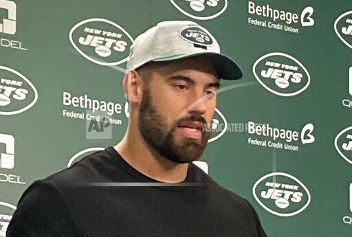 New York Jets offensive lineman Laurent Duvernay-Tardif speaks to reporters at the team's facility in Florham Park, N.J., on Wednesday, Nov. 24, 2021. Duvernay-Tardif was coming off having won a Super Bowl with the Kansas City Chiefs in his sixth year in the NFL when he began working as an orderly at a long-term care facility. He's back playing football now and starting for the Jets. (AP Photo/Dennis Waszak Jr.)