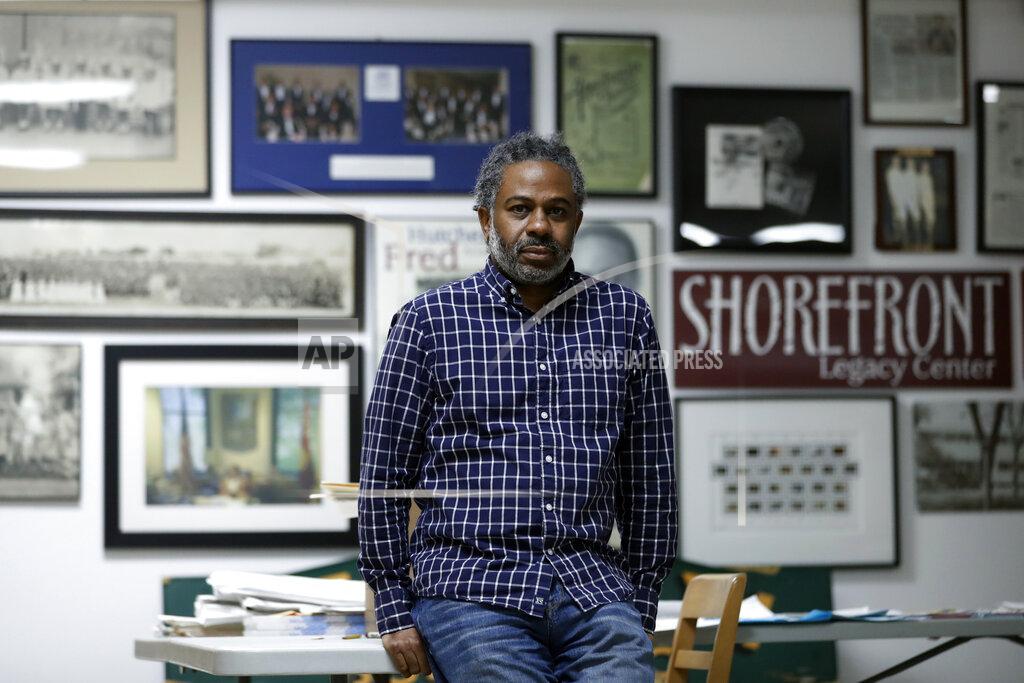 Shafkat Anowar Evanston's local historian Morris "Dino" Robinson Jr., who co-authored a city-commissioned study on housing practices, poses for a portrait in Shorefront Legacy Center in Evanston, Ill., Friday, April 9, 2021. The Chicago suburb is preparing to pay reparations in the form of housing grants to Black residents who experienced housing discrimination. “It’s a lot, a lot of work, and be prepared for pulling back old wounds, telling truth, gaining the trust,” Robinson said. (AP Photo/Shafkat Anowar)