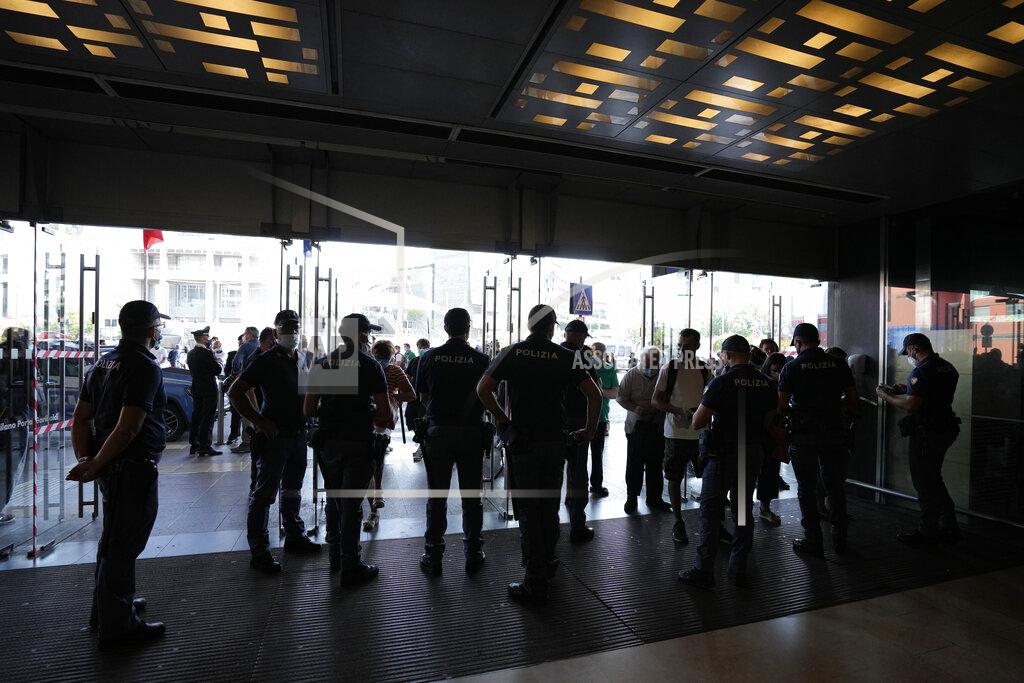Luca Bruno Police officers check passenger's documents at the entrance of Porta Garibaldi train station, in Milan, Italy, Wednesday, Sept. 2, 2021. Italy's government vowed to crack down on demonstrators threatening to block train tracks throughout the country Wednesday as a rule requiring COVID-19 tests or vaccines to use public transportation for long-distance domestic travel took effect. (AP Photo/Luca Bruno)