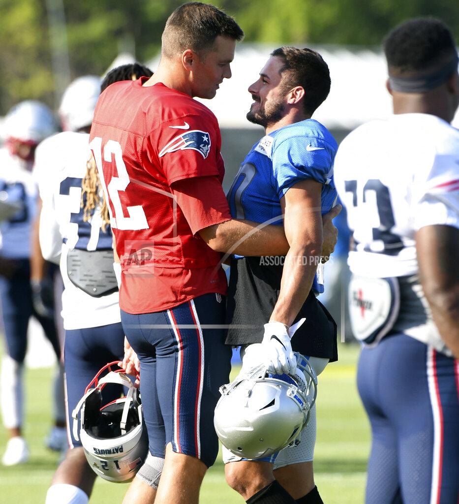New England Patriots quarterback Tom Brady, left, hugs former teammate Detroit Lions wide receiver Danny Amendola as they make their way onto the field for a combined NFL football practice in Allen Park, Mich., Monday, Aug. 5, 2019. (Daniel Mears/Detroit News via AP)
