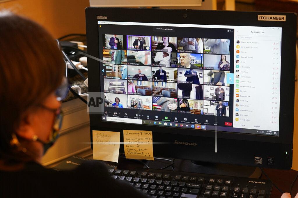 Steve Helber Deputy Clerk for Information Technology, Sharon Steidel, monitors a Virginia House of Delegates Zoom Legislative session off the chambers floor at the Capitol in Richmond, Va., Wednesday, Feb. 10, 2021. (AP Photo/Steve Helber)