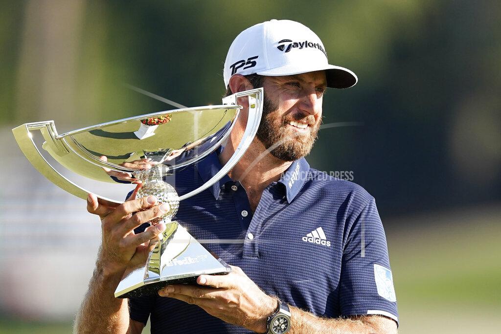 John Bazemore Dustin Johnson holds up the FedEx Cup trophy after winning the Tour Championship golf tournament on Monday, Sept. 7, 2020 at Lake Golf Club in Atlanta. (AP Photo/John Bazemore)
