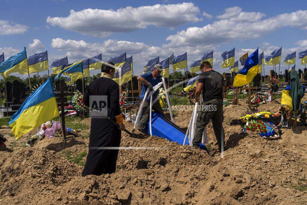 Bernat Armangue Undertakers lower the coffin of Ukrainian serviceman Oleksander Matyukhin, 32, in Kharkiv, eastern Ukraine, Monday, May 23, 2022. (AP Photo/Bernat Armangue)