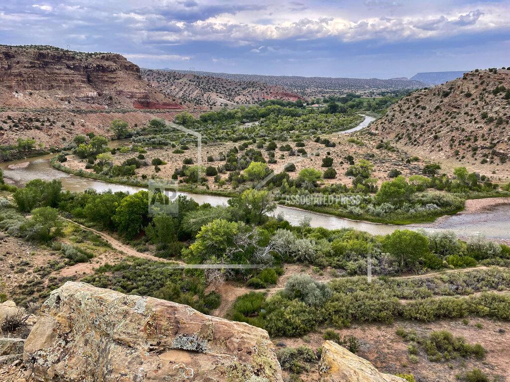 Susan Montoya Bryan This Aug. 31, 2021 photo shows the Rio Chama coursing through a high desert landscape near Abiquiu, New Mexico. Traditional irrigation systems known as acequias that depend on the river are feeling more pressure as drought persists and climate change piles on with warmer temperatures. (AP Photo/Susan Montoya Bryan)
