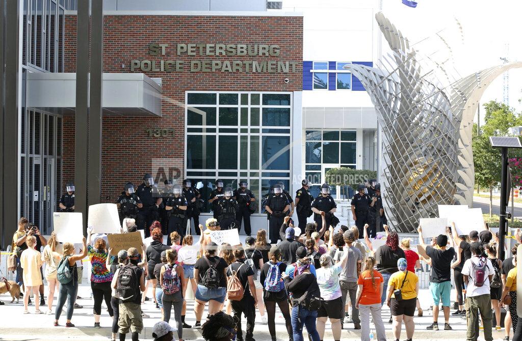 Scott Keeler Protesters gather outside of the St. Petersburg (Fla.) Police Department, Sunday, May 31, 2020, to protest the death of George Floyd, who died May 25 after he was pinned at the neck by a Minneapolis police officer. (Scott Keeler/Tampa Bay Times via AP)