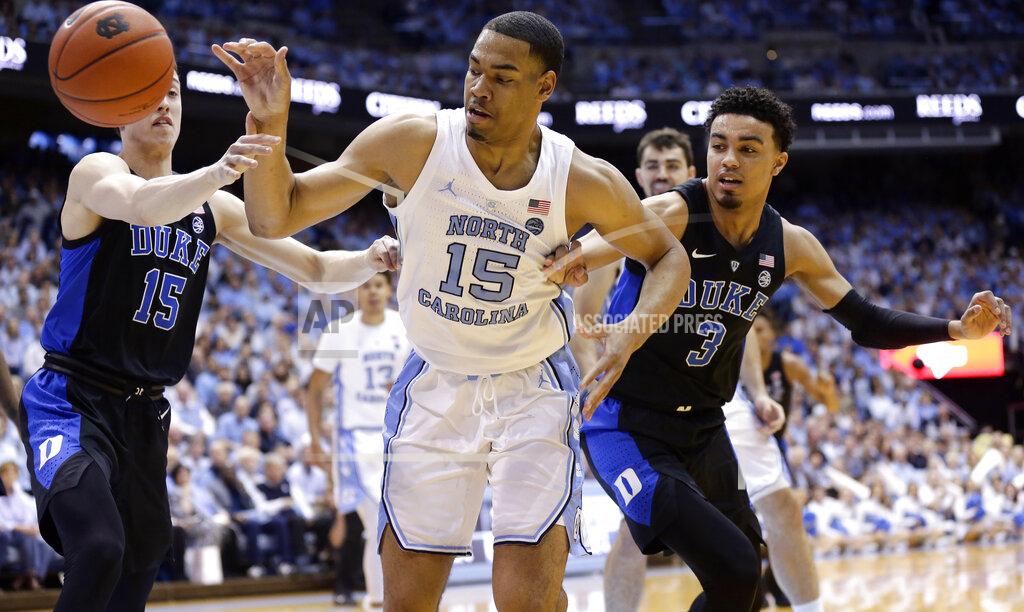 Gerry Broome North Carolina's Garrison Brooks (15) reaches for the ball against Duke's Alex O'Connell (15) and Tre Jones (3) during the first half of an NCAA college basketball game in Chapel Hill, N.C., Saturday, March 9, 2019. (AP Photo/Gerry Broome)