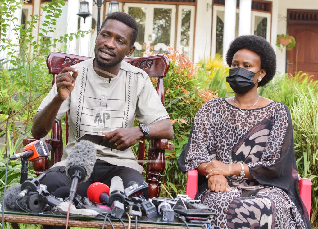 Nicholas Bamulanzeki Uganda's leading opposition challenger Bobi Wine, left, and his wife Barbie Kyagulanyi, give a press conference after casting their votes in Kampala, Uganda, Thursday, Jan. 14, 2021. Long lines of Ugandans are voting in a presidential election tainted by widespread violence that some fear could escalate as security forces try to stop supporters of leading opposition challenger Bobi Wine from monitoring polling stations. (AP Photo/Nicholas Bamulanzeki)