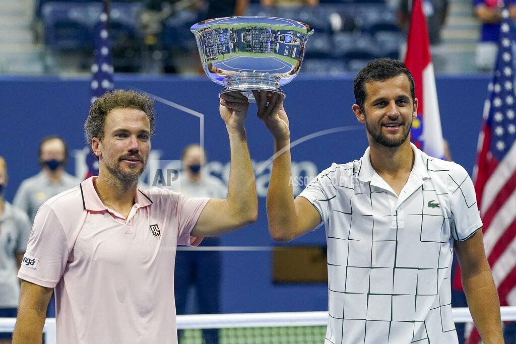 Seth Wenig Bruno Soares, of Brazil, left, and Mate Pavic, of Croatia, hold up the championship trophy after winning the men's doubles final against Wesley Koolhof, of the Netherlands, and Nikola Mektic, of Croatia, during the US Open tennis championships, Thursday, Sept. 10, 2020, in New York. (AP Photo/Seth Wenig)