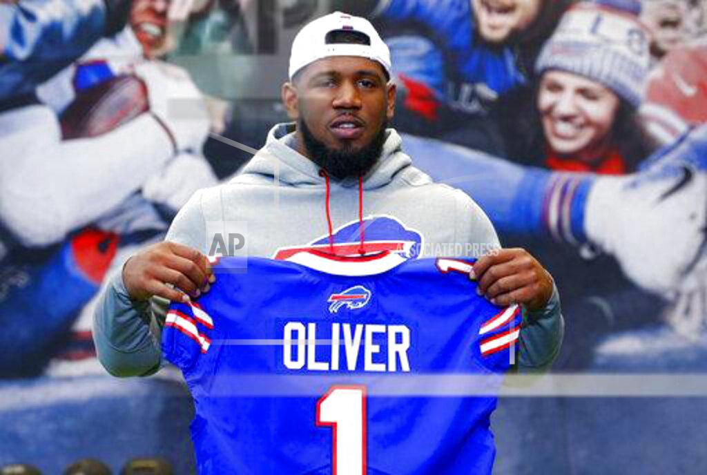 Jeffrey T. Barnes File-This April 27, 2019, file photo shows Buffalo Bills first round draft pick Ed Oliver posing for photographs following an NFL football news conference in Orchard Park N.Y. Oliver was arrested Saturday, May 16, 2020, by police in the Houston area and charged with drunk driving and illegally carrying a gun. Montgomery County sheriff’s deputies pulled Oliver over after receiving reports around 9 p.m. of someone driving recklessly in a construction area north of the city, local media outlets reported, citing jail and police records and statements from sheriff's officials. (AP Photo/Jeffrey T. Barnes, File)