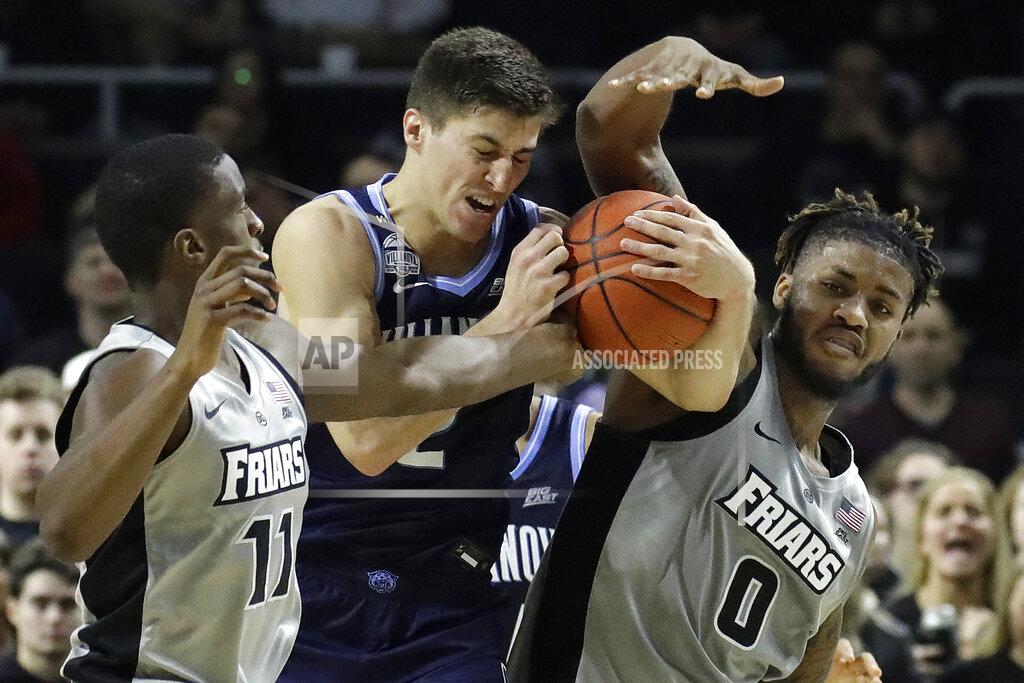 Elise Amendola Villanova guard Collin Gillespie, center, fights for a rebound with Providence guard Alpha Diallo, left, and center Nate Watson, right, in the first half of an NCAA college basketball game, Saturday, Jan. 25, 2020, in Providence, R.I. (AP Photo/Elise Amendola)