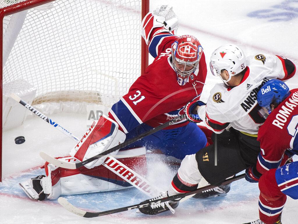 Graham Hughes Montreal Canadiens goaltender Carey Price makes a save against Ottawa Senators' Artem Anisimov (51) as Canadiens' Alexander Romanov defends during the second period of an NHL hockey game in Montreal, Saturday, April 3, 2021. (Graham Hughes/The Canadian Press via AP)