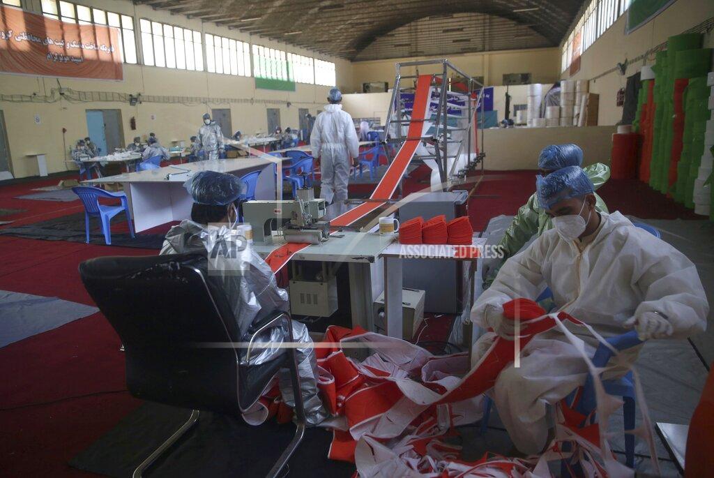 Rahmat Gul FILE- In this June 3, 2020 file photo, workers make protective face masks to be used to help curb the spread of the coronavirus at a factory in Kabul, Afghanistan. The confirmed death toll from the coronavirus has gone over 50,000 in the Middle East as the pandemic continues. That's according to a count Thursday, Sept. 3, 2020, from The Associated Press, based on official numbers offered by health authorities across the region. (AP Photo/Rahmat Gul, File)