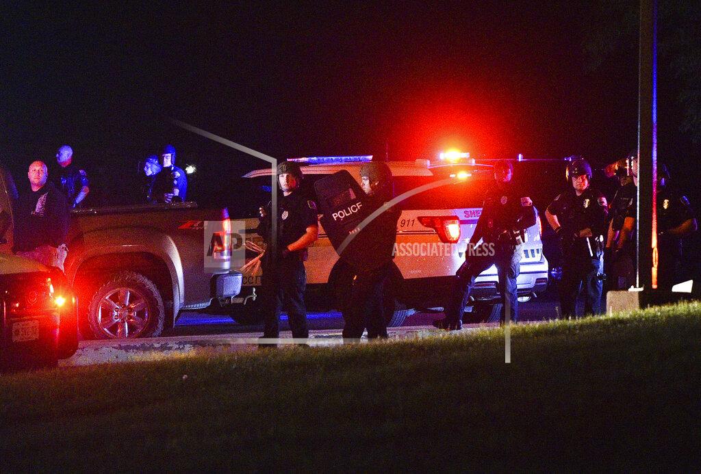 Meg Mclaughlin A heavy police presence is seen near an entrance of NorthPark Mall along West Kimberly Road Monday, June 1, 2020, in Davenport, Iowa. Two people are dead and a police officer was wounded in a round of rioting and violence that occurred Sunday night into Monday morning in Davenport. (Meg McLaughlin/Quad City Times via AP)