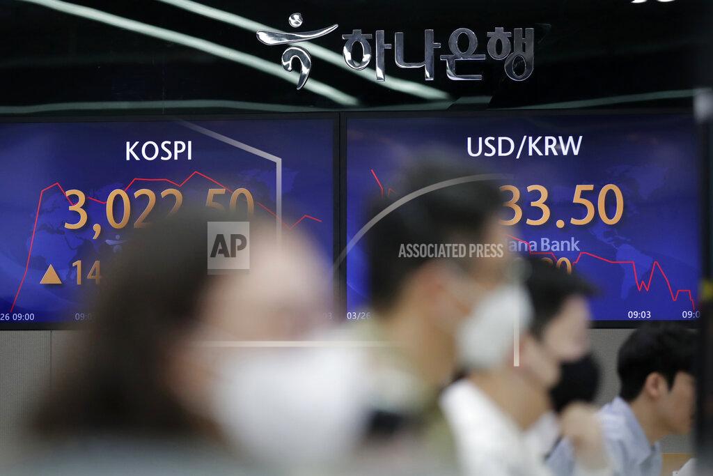 Lee Jin-Man Currency traders watch their computer monitors near the screens showing the Korea Composite Stock Price Index (KOSPI), left, and the foreign exchange rate between U.S. dollar and South Korean won at the foreign exchange dealing room in Seoul, South Korea, Friday, March 26, 2021. Shares were higher across Asia on Friday after a strong gains on Wall Street driven by hopes for a powerful recovery from the pandemic. (AP Photo/Lee Jin-man)