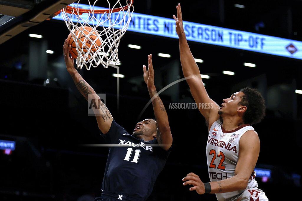 Adam Hunger Xavier's Dwon Odom (11) drives to the basket past Virginia Tech's Keve Aluma (22) during the first half of an NCAA college basketball game in the NIT Season Tip-Off tournament Friday, Nov. 26, 2021, in New York. (AP Photo/Adam Hunger)