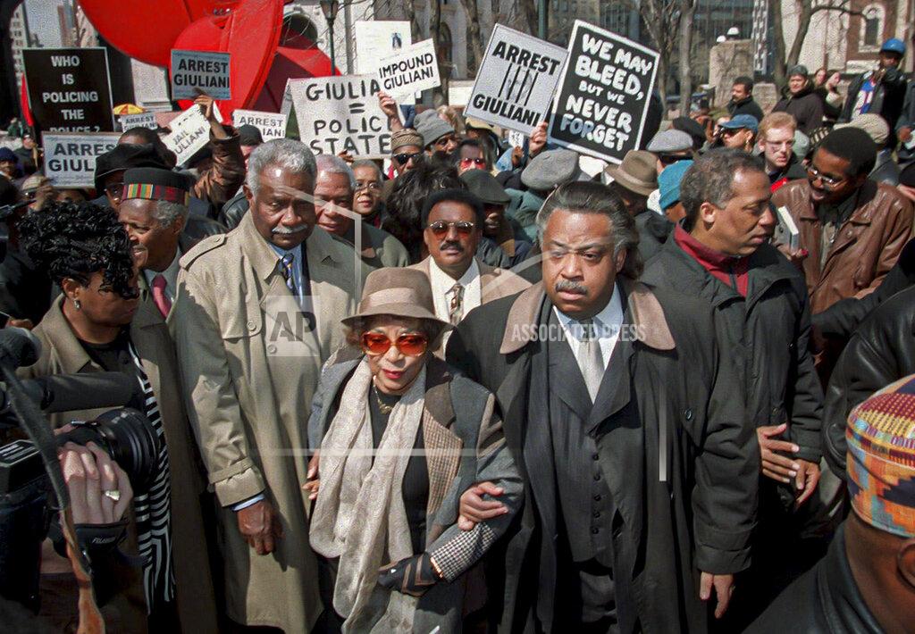 Ed Bailey FILE - In this March 23, 1999, file photo, the Rev. Al Sharpton, center right, walks with actors and activists Ruby Dee, center, and her husband Ossie Davis, center left, at New York's police headquarters during protests calling for the arrest of the police officers who fired 41 bullets at West African immigrant Amadou Diallo, killing him. For more than three decades, Sharpton, 65, has been a go-to advocate for Black American families seeking justice and peace in the wake of violence and countless incidents that highlight systemic racism. (AP Photo/Ed Bailey, File)