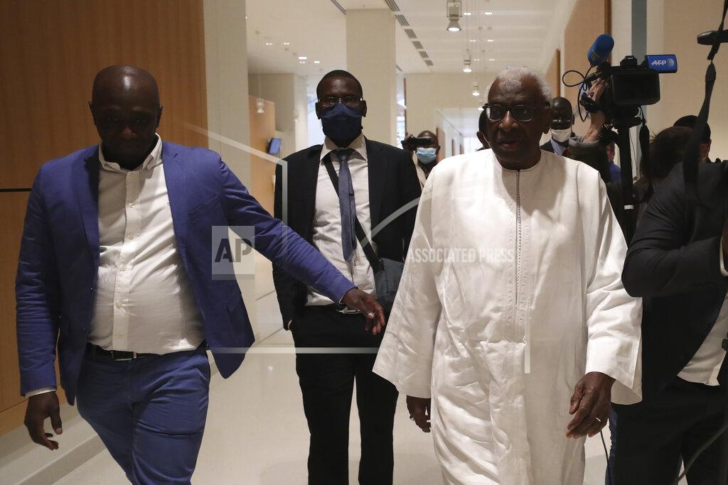 Thibault Camus Former president of the IAAF (International Association of Athletics Federations) Lamine Diack, right, arrives at the Paris courthouse, Wednesday, June 10, 2020. A sweeping sports corruption trial opened Monday in Paris involving allegations of a massive doping cover-up that reached to the top of world track and field's governing body. Lamine Diack, 87, who served as president of the body for nearly 16 years, is among those accused of receiving money from Russian athletes to hide their suspected doping so they could compete at the Olympics in 2012 and other competitions. (AP Photo/Thibault Camus)