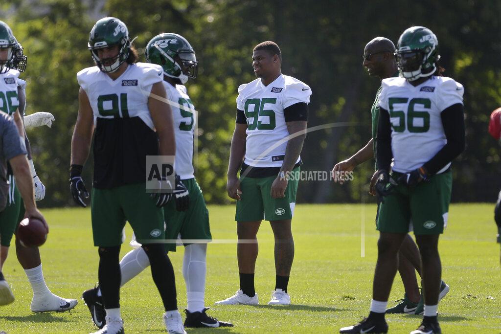 Seth Wenig New York Jets' Quinnen Williams (95), center, looks on while others participate in a practice at the NFL football team's training camp in Florham Park, N.J., Friday, July 26, 2019. (AP Photo/Seth Wenig)